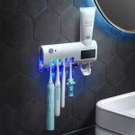 Toothbrush/paste holder with sterilizer
